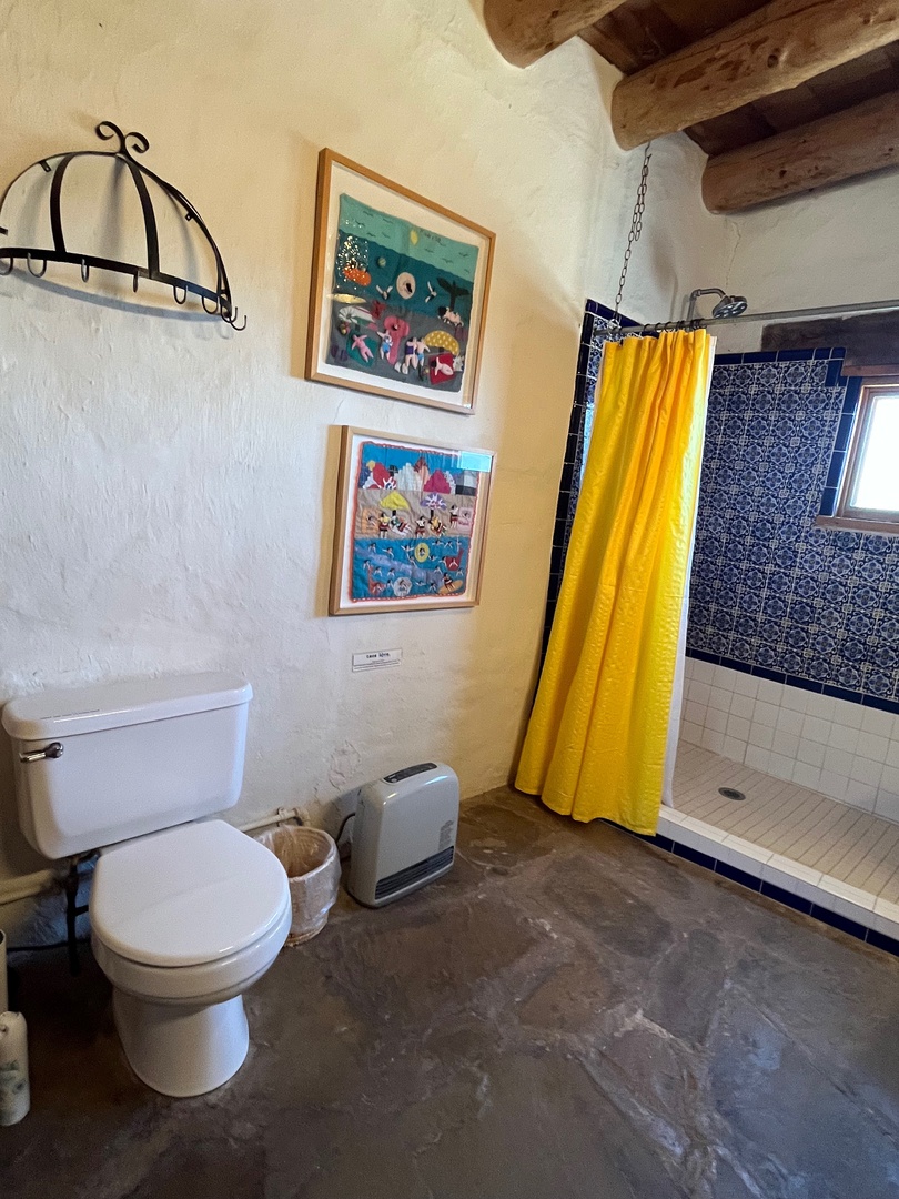Private bath with shower, vanity and toilet.