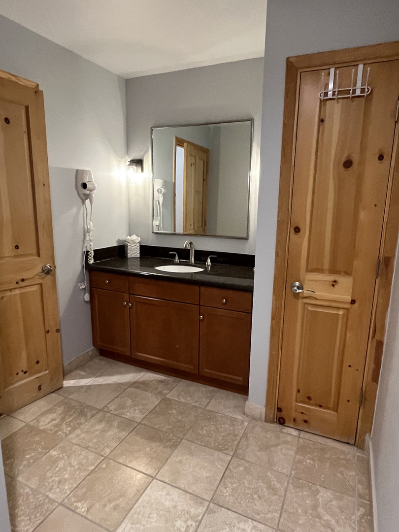 The vanity is in the bedroom space, around a corner, and the wc itself with toilet and shower has a door for privacy