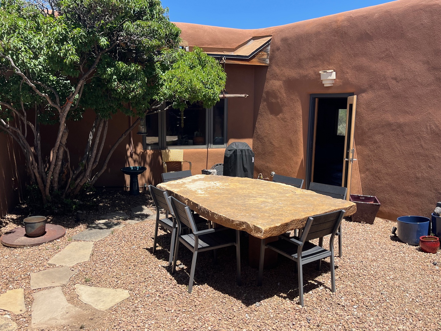Exit the house adjacent to the kitchen to expand into this beautiful courtyard with stone dining table
