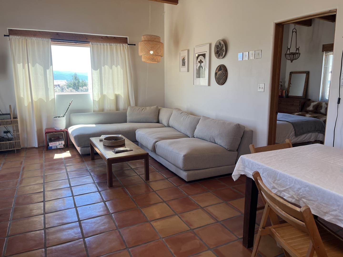 Unwind in your spacious living area with plush sectional seating and charming terracotta floors that warm the entire space.