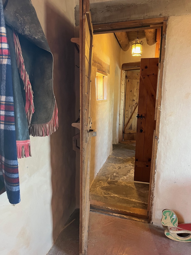 The hallway between the king and queen bedrooms that share the hall bathroom