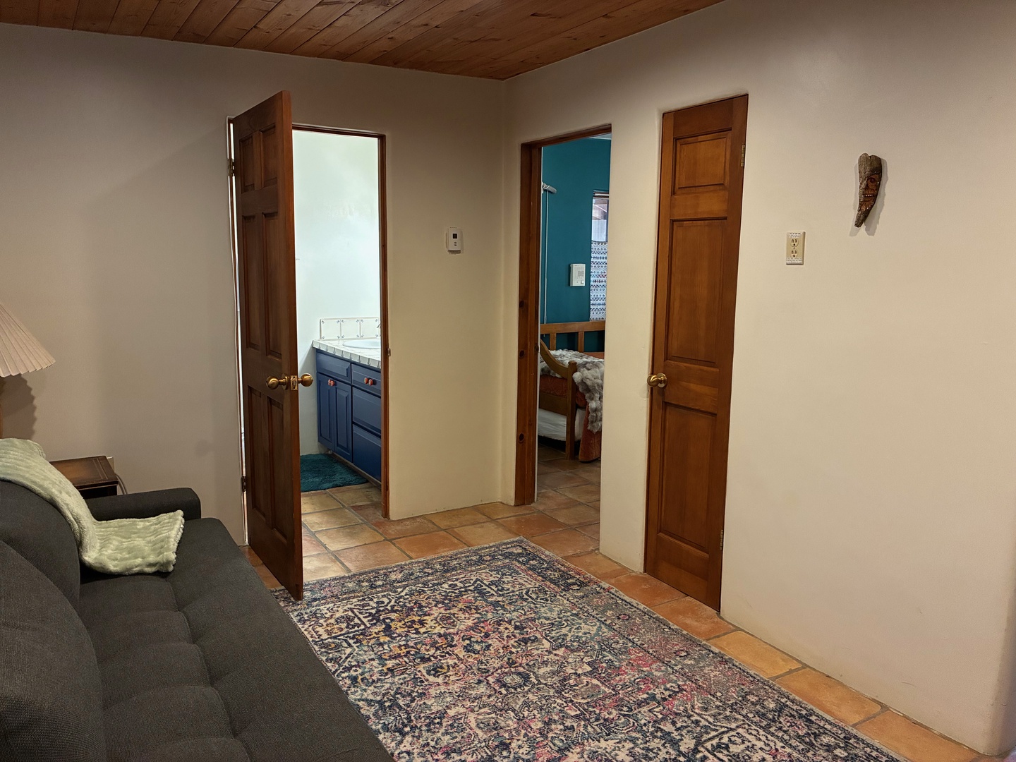 Your private retreat features charming wood-paneled ceilings and terra-cotta tile floors connecting a cozy sitting area to your restful bedroom and en-suite bath.
