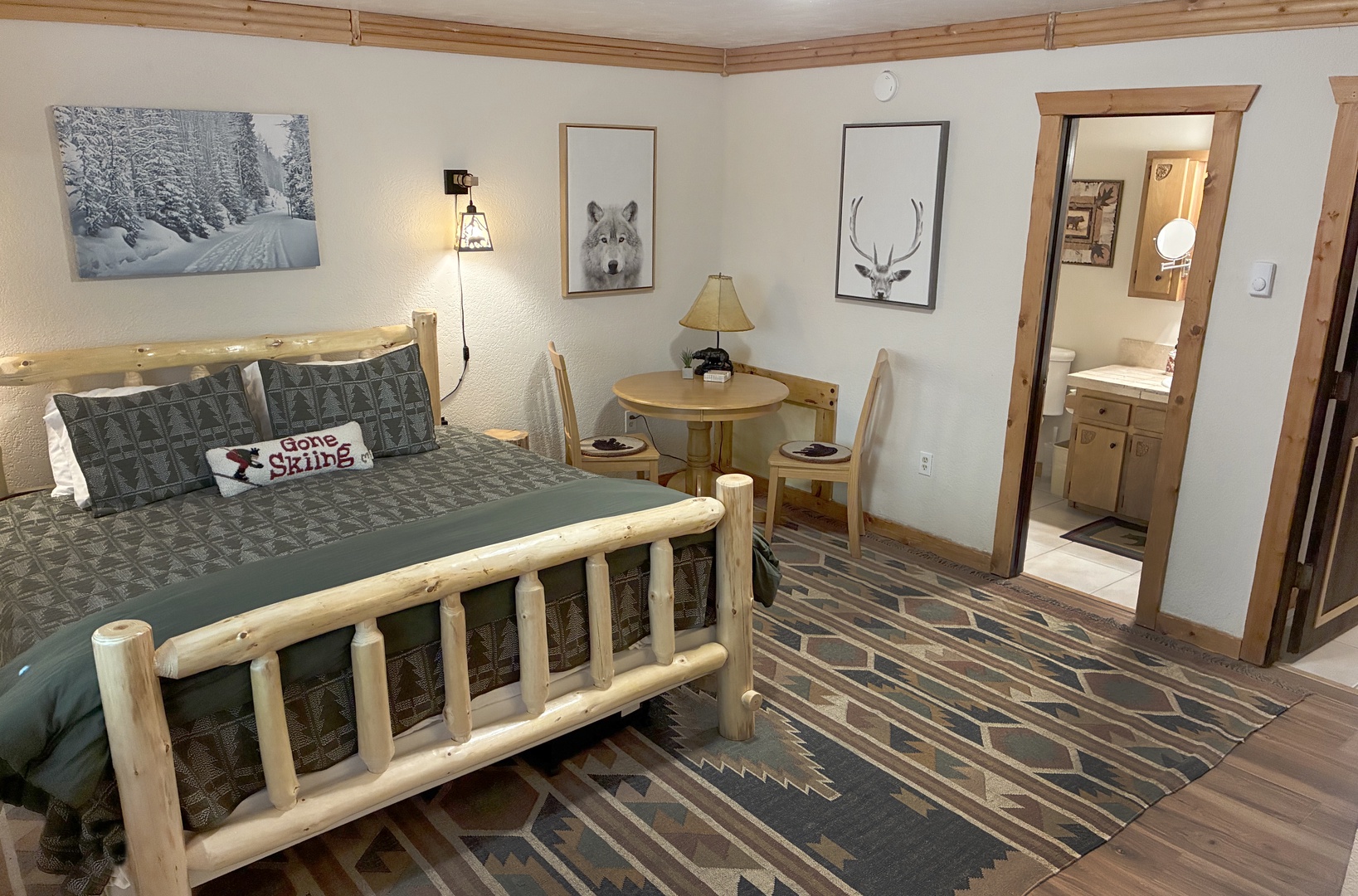 Cozy up in your rustic retreat with natural wood furnishings and mountain-inspired décor. Your private bathroom awaits just steps away, while a welcoming table invites quiet mornings with coffee.