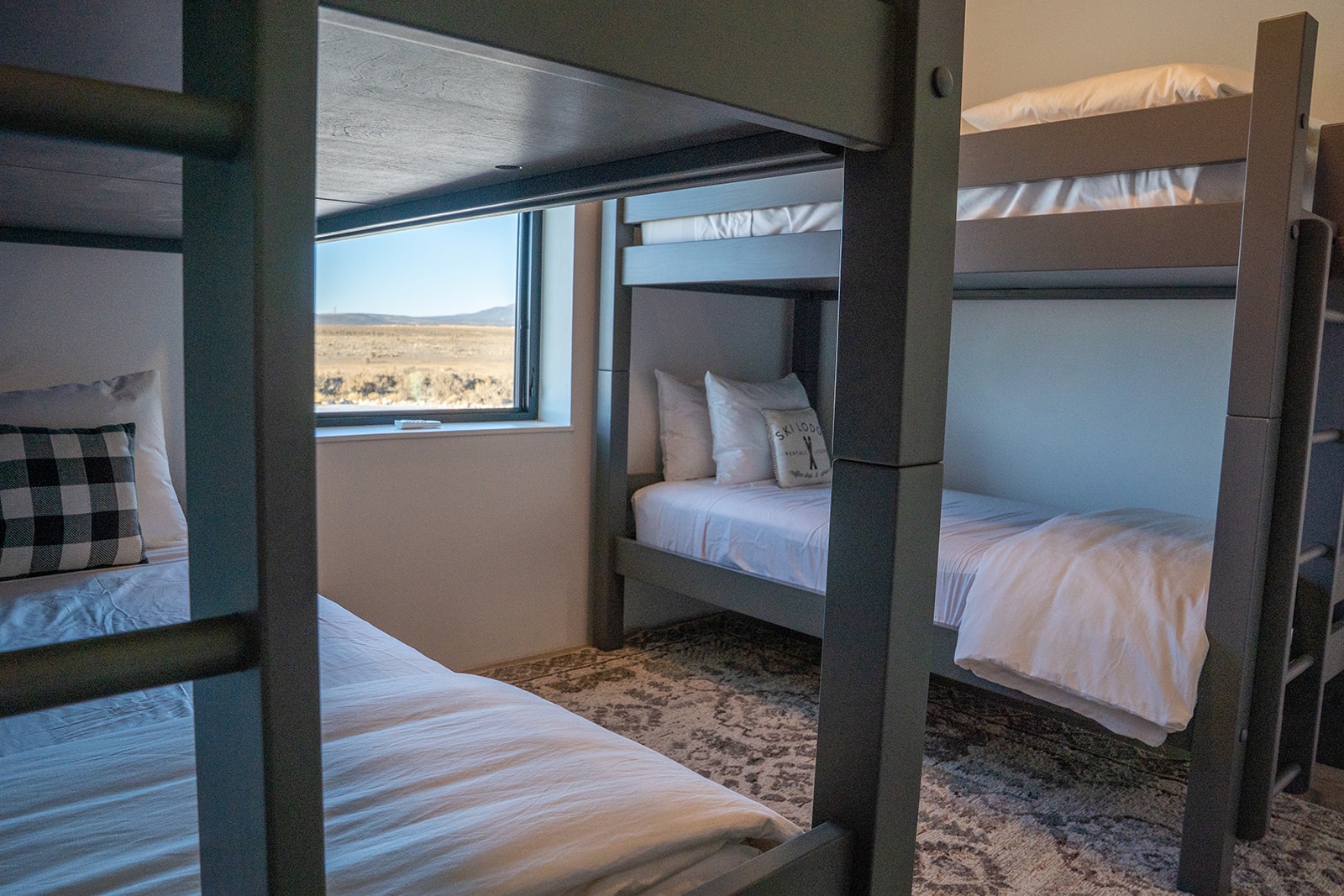 Cozy bunk room with mountain views - perfect for families or groups seeking comfortable shared sleeping arrangements.