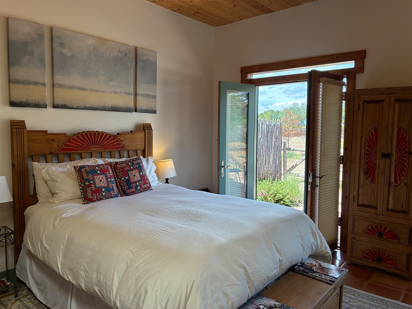 Sink into soft linens and wake to peaceful views through your private patio doors, with warm wood accents and vibrant décor.