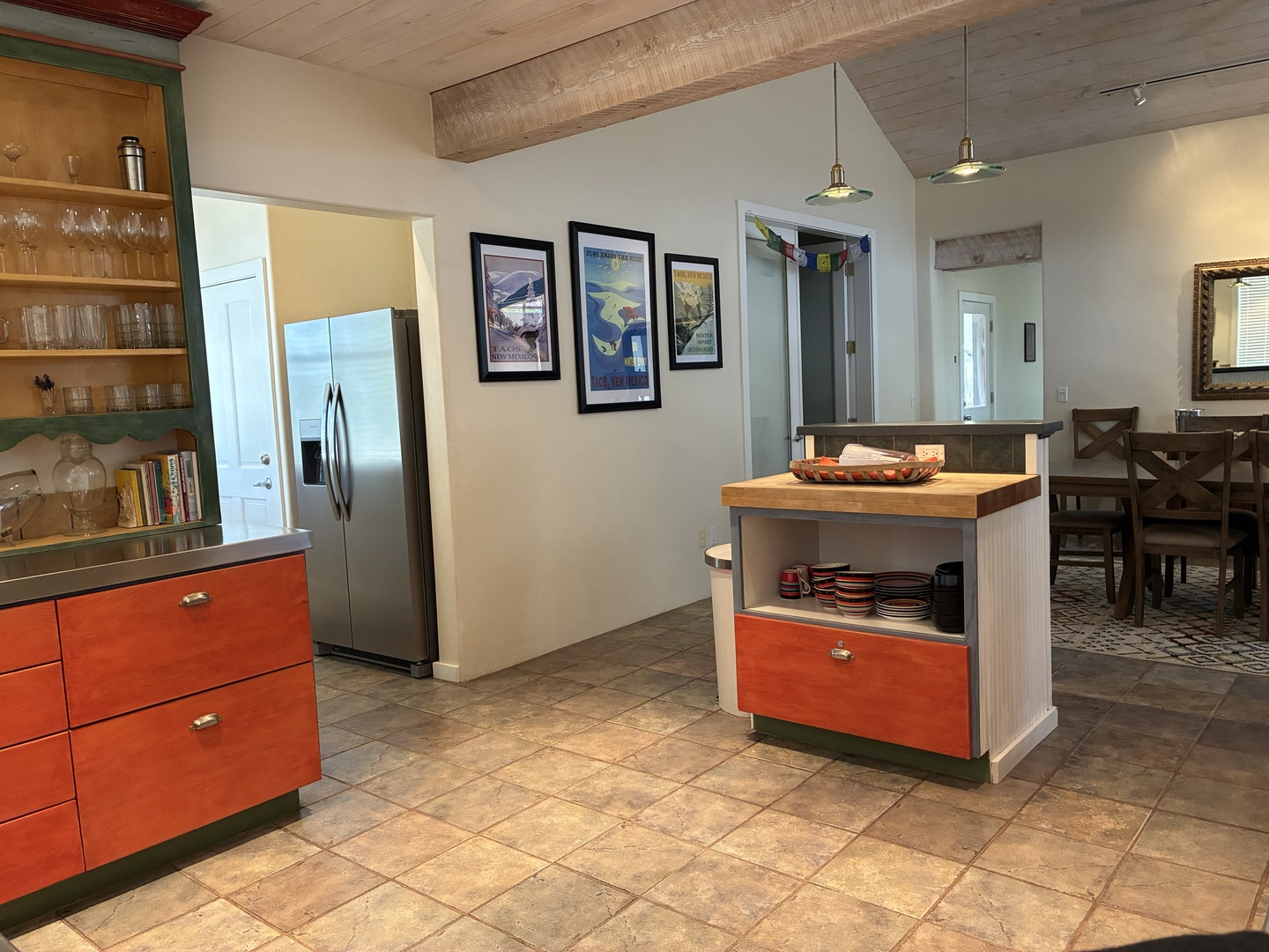 Your fully equipped kitchen features colorful coral cabinetry, stainless steel appliances, and plenty of prep space—perfect for whipping up your favorite meals or grabbing a quick snack between adventures.