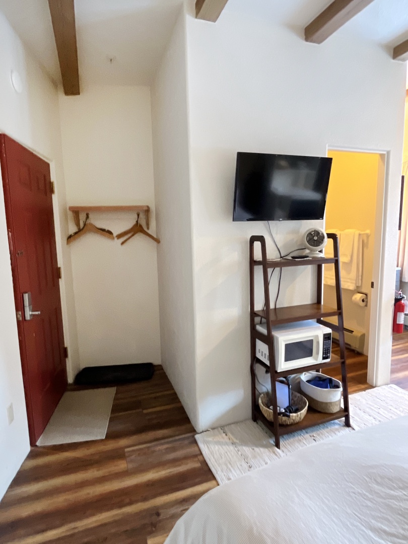 Your cozy room features exposed beams, flat-screen TV, microwave, and thoughtful amenities with rustic charm.