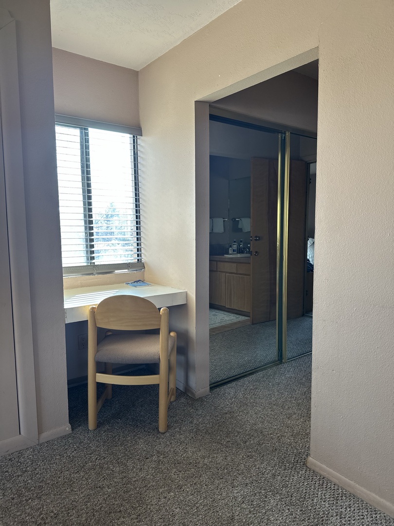 Your bright workspace by the window offers natural light for productivity, while your private bathroom awaits just steps away.