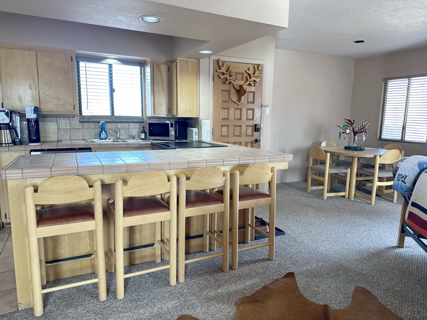 Your spacious kitchen features tiled counters, full appliances, and a breakfast bar where you'll gather for memorable meals and morning coffee.