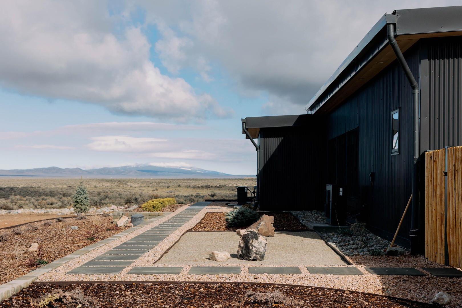 Modern desert retreat set against endless high desert plains and distant mountain ranges, offering complete seclusion and open skies.