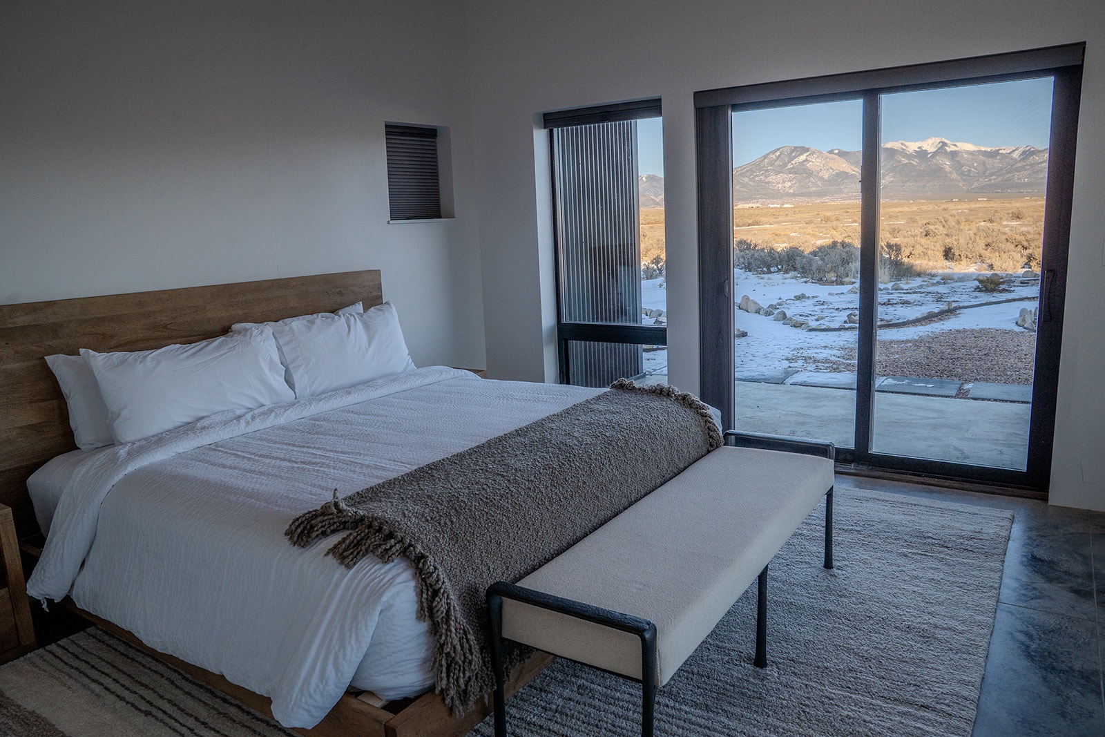 Wake up to stunning mountain views from your cozy bedroom, where crisp linens and modern comfort meet dramatic winter landscapes outside your door.