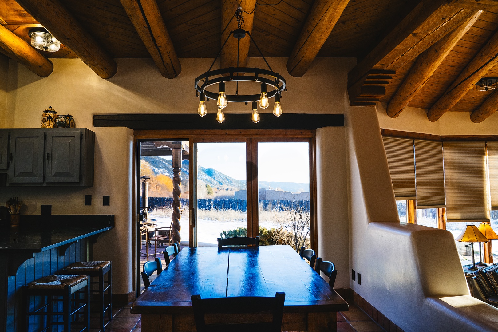 Gather around your rustic dining table where exposed beams and warm lighting create intimate meals with stunning mountain views.