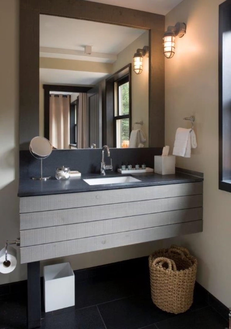 Your modern bathroom features a sleek floating vanity, nautical-inspired sconces, and thoughtful amenities—everything you need to feel refreshed and at home.