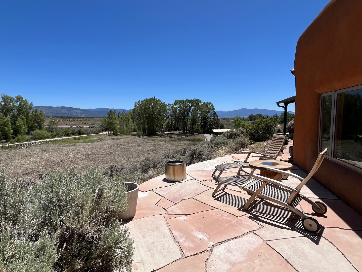 Unwind on your private patio with sweeping views of rugged mountains and open desert landscapes, where two lounge chairs invite you to soak in the peaceful beauty and fresh air.