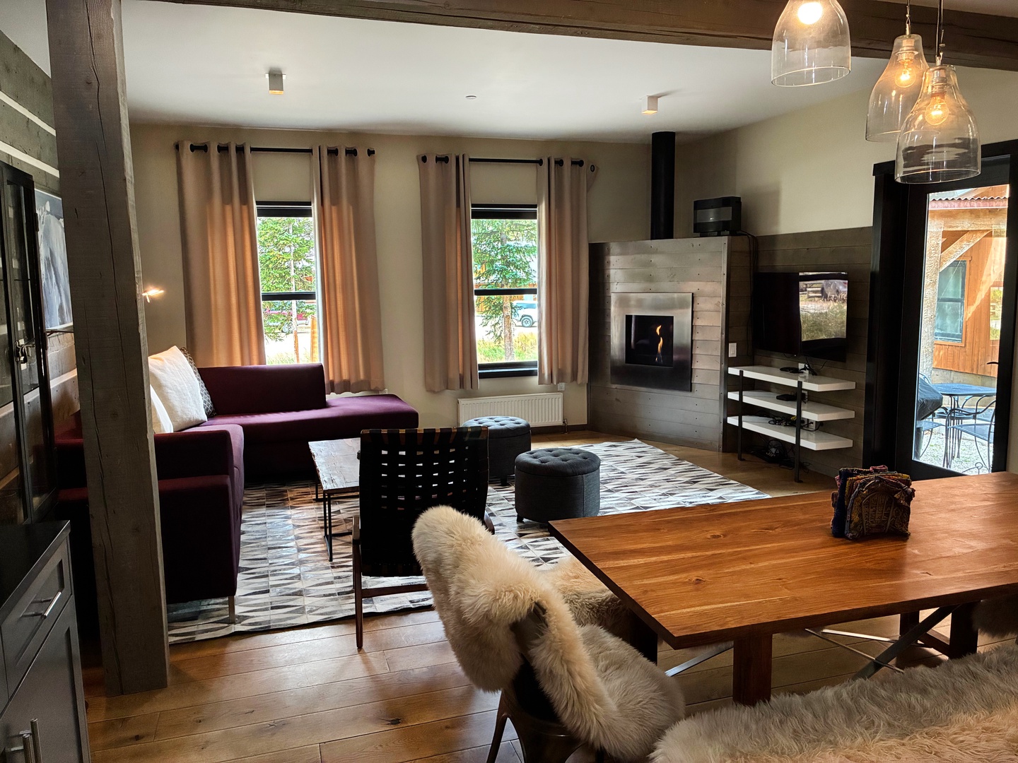 Unwind in your open-concept living space, where warm wood floors, a cozy fireplace, and modern furnishings invite you to settle in and feel at home.