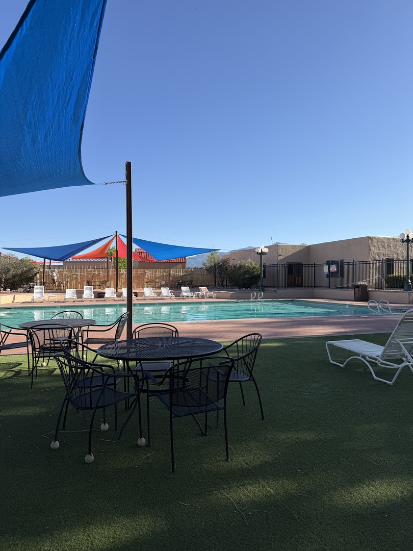 Relax in your poolside retreat, where shaded seating and mountain views create the perfect backdrop for your sunny desert escape.