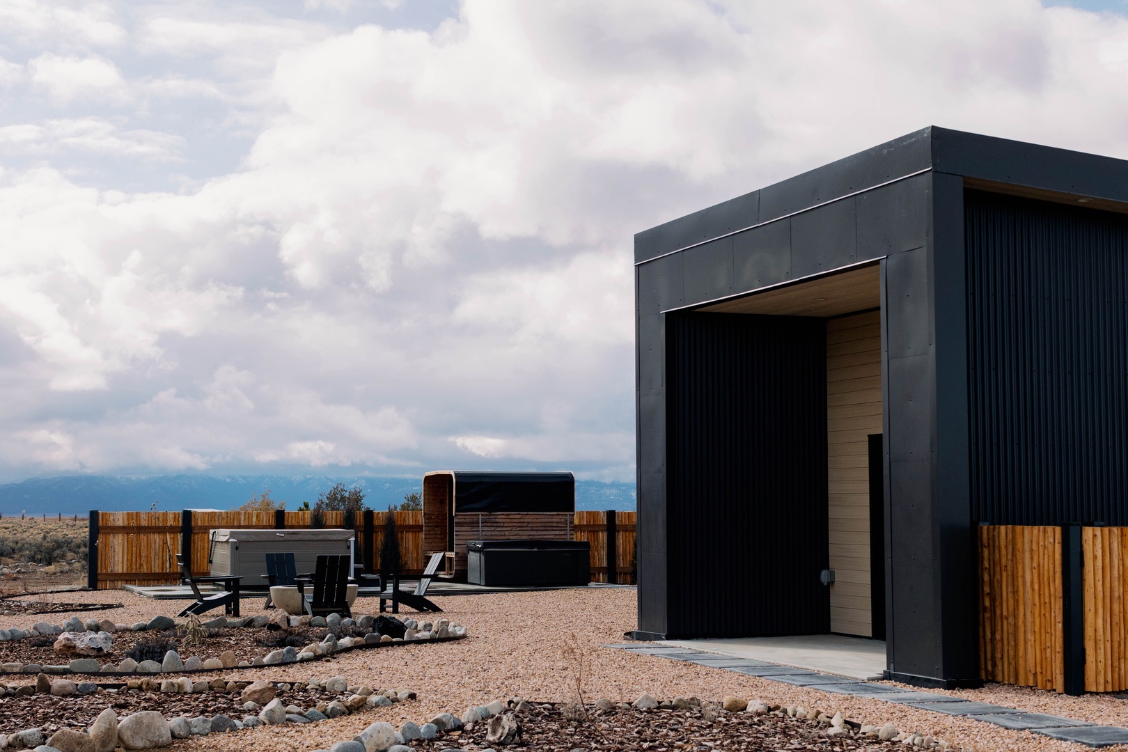 Modern architectural retreat set in a vast desert landscape, featuring bold geometric design and striking natural surroundings perfect for remote escape.