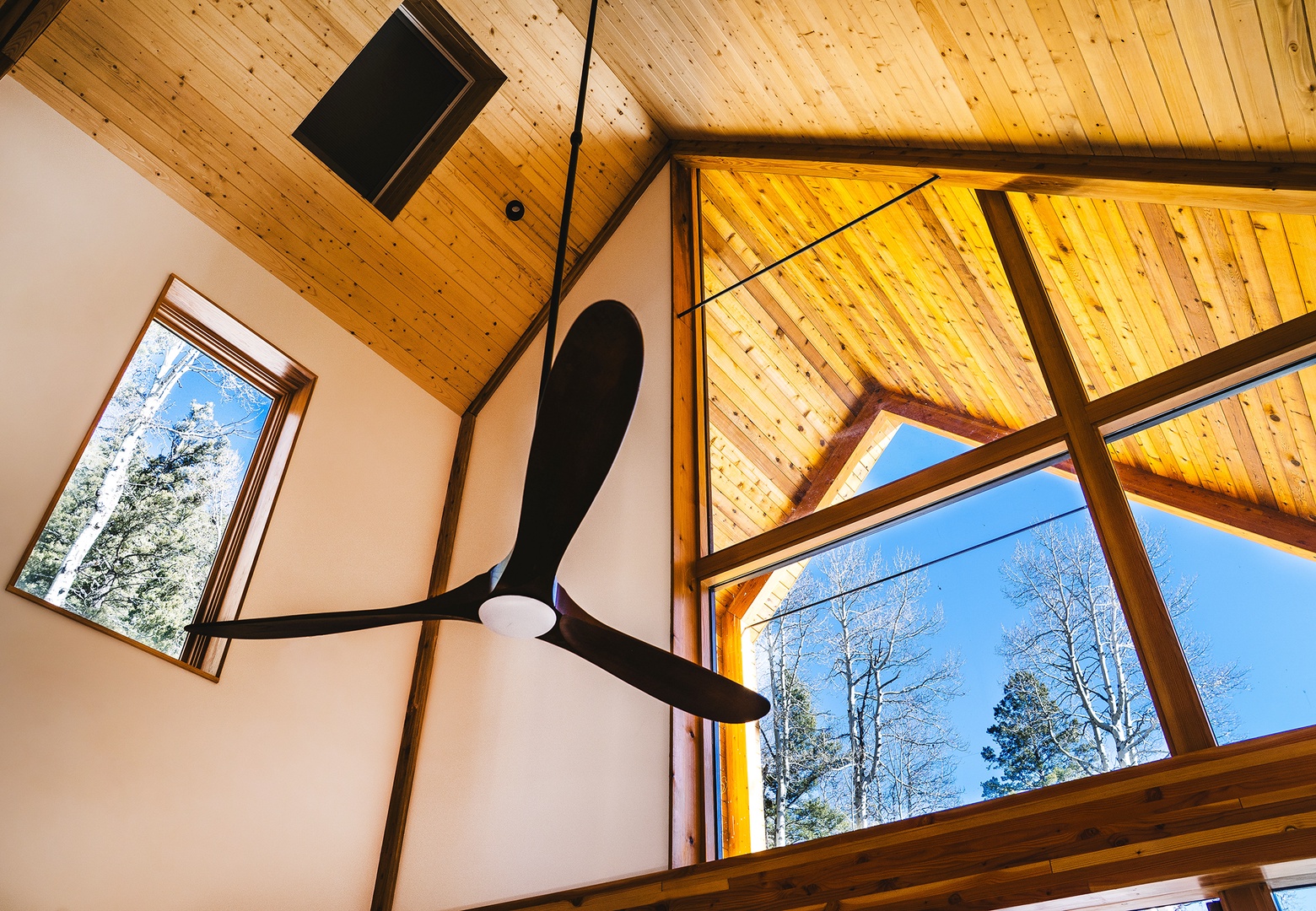 High wood beam ceilings, metal and glass define this modern space