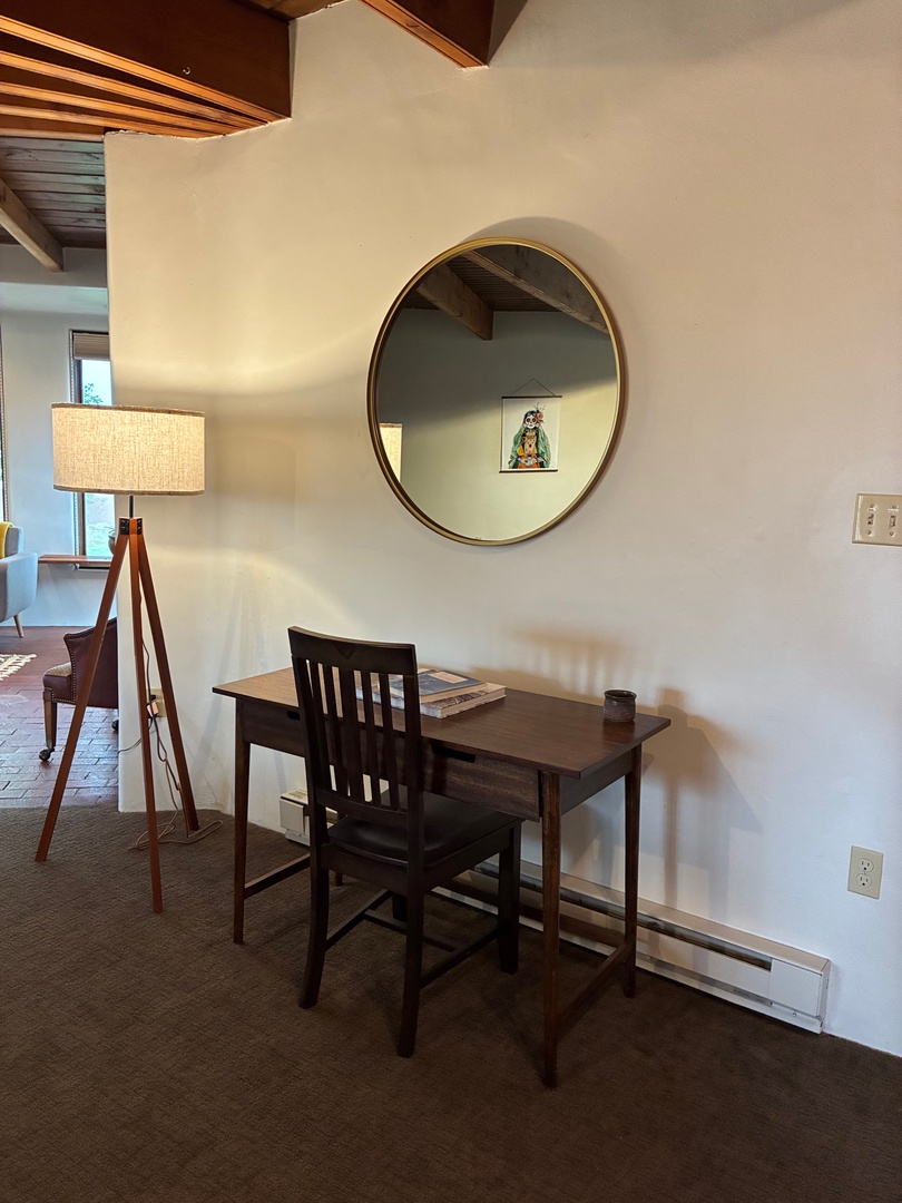 Find your perfect spot at this cozy work desk, where warm wood tones and thoughtful design create an inspiring space for catching up on emails or planning your next adventure.