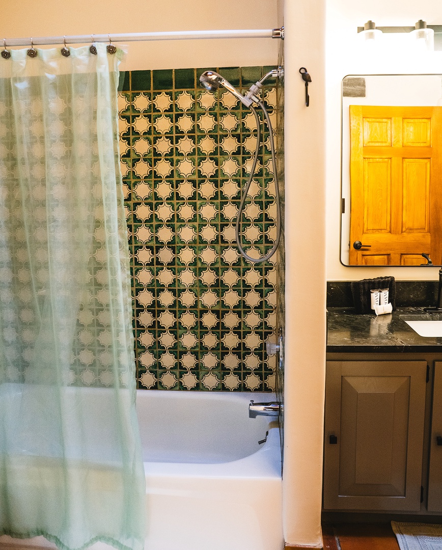 Unwind in your stylish bathroom featuring beautiful patterned tiles and a relaxing tub-shower combo with premium fixtures.