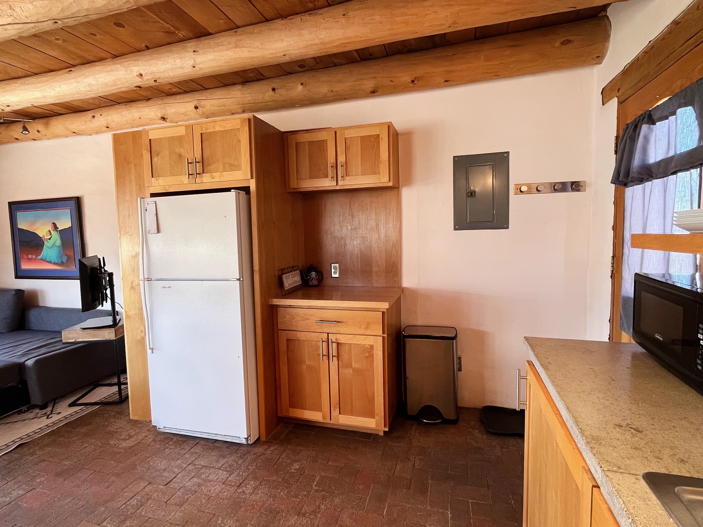 Full size refrigerator and extra storage in the kitchen