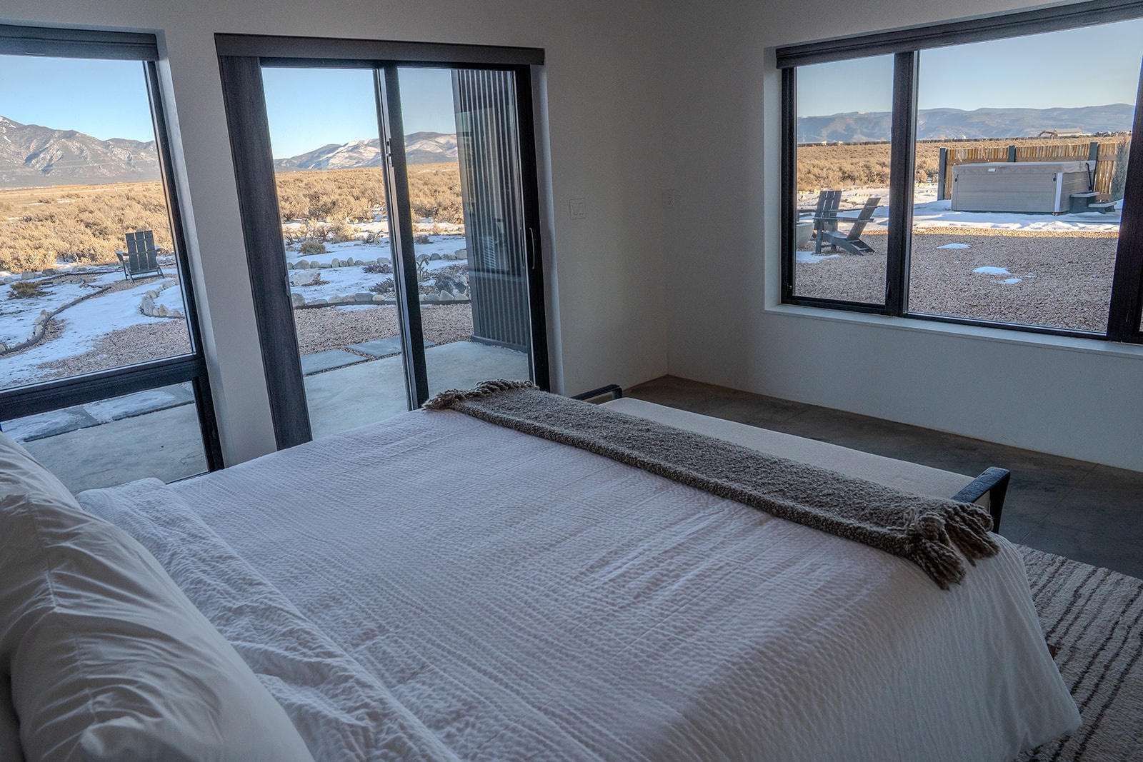 Wake up to breathtaking mountain vistas through your bedroom's floor-to-ceiling windows, where crisp linens await your restful nights.