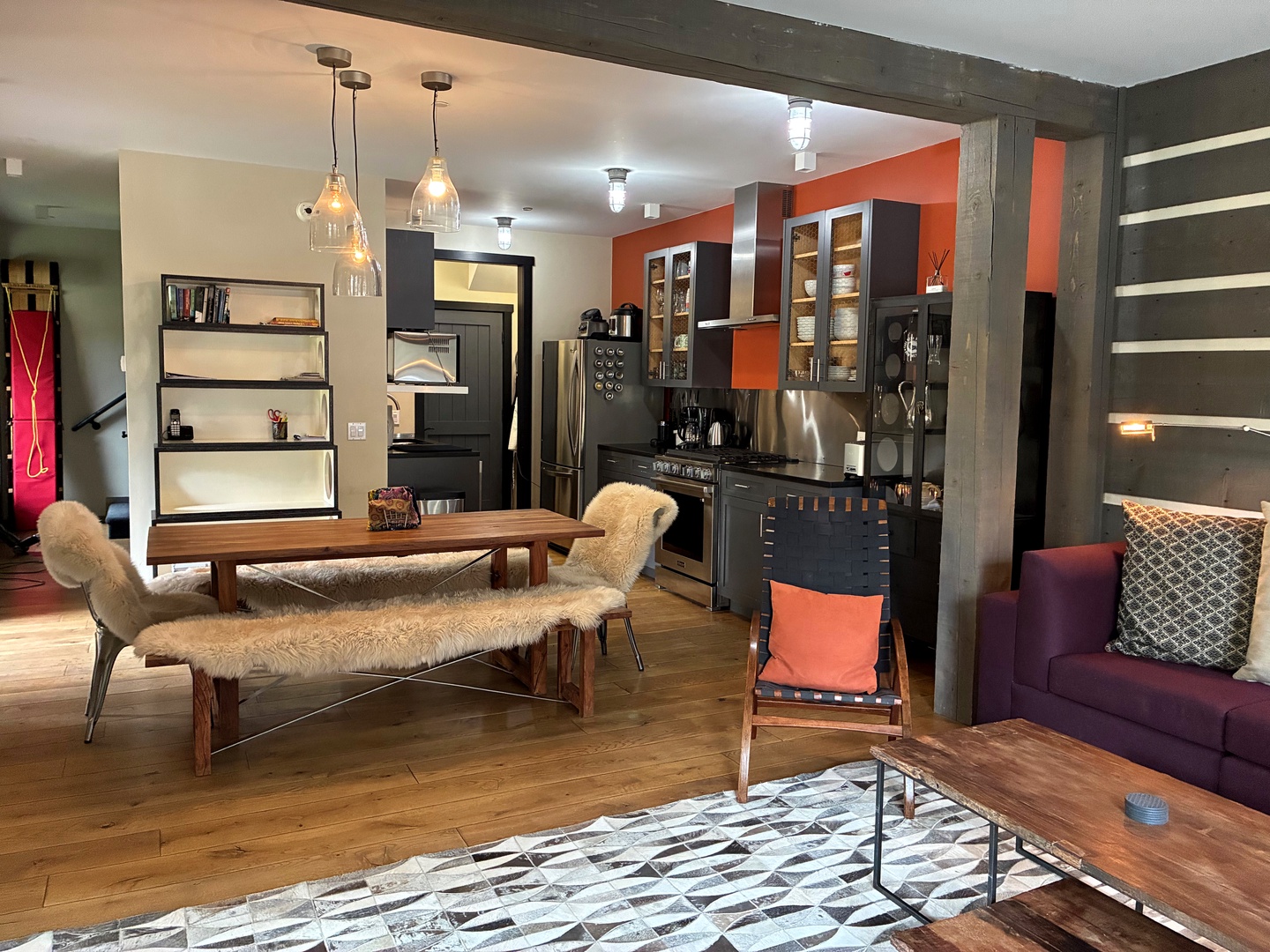 You'll love the open layout where warm wood tones and vibrant accent colors create a welcoming vibe. Settle into the cozy seating, enjoy the fully-equipped kitchen, and feel right at home in this stylish space.