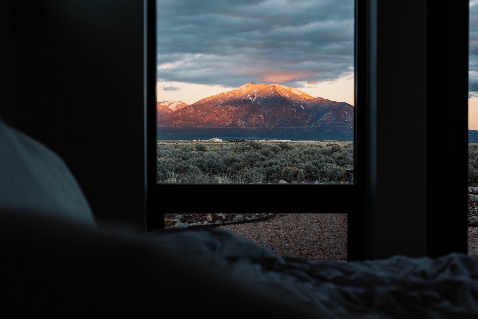 Wake up to snow-capped peaks bathed in golden light, framed perfectly through your bedroom window. Your mountain escape awaits just beyond the glass.