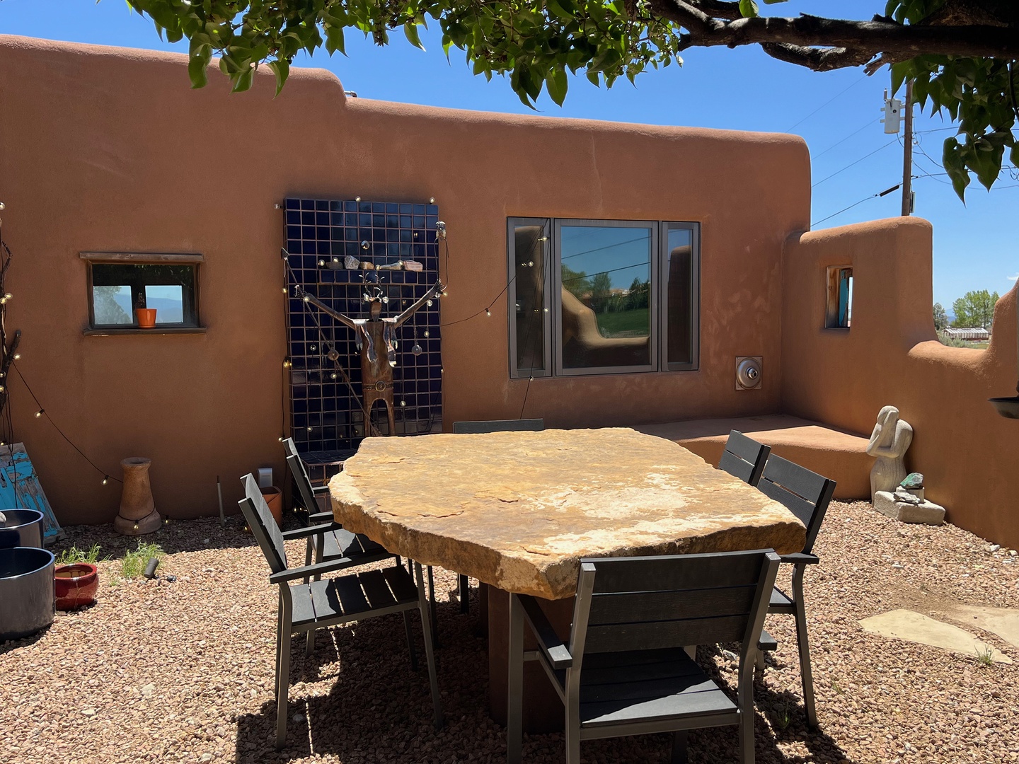 Beautiful private dining patio with artwork and string lights
