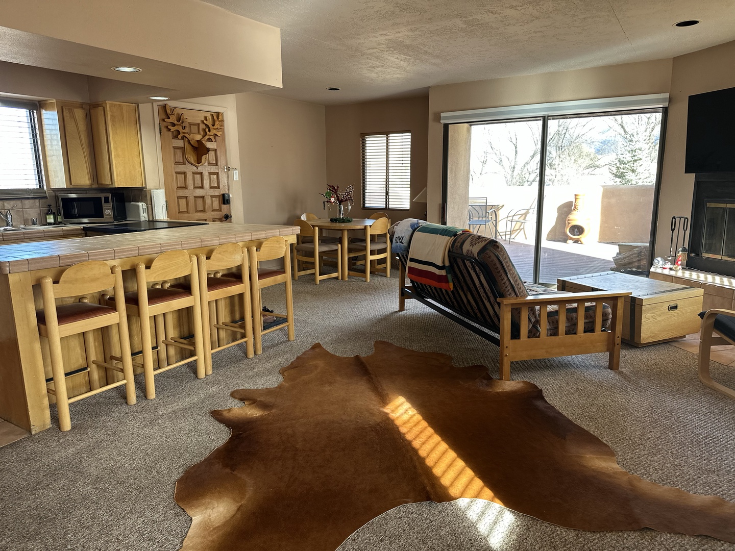 Relax in your cozy living space with rustic charm, where warm wood furniture meets Native American-inspired décor and a crackling fireplace awaits.