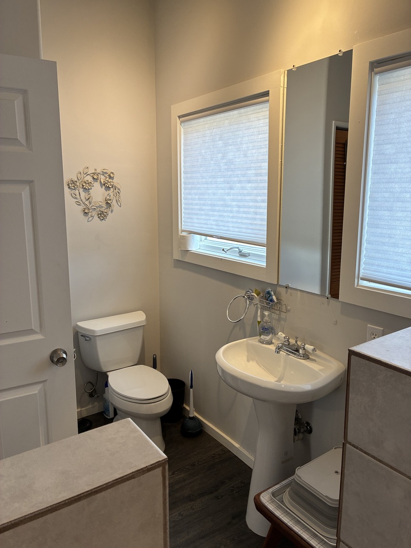 Freshen up in your private bathroom with natural light streaming through the windows, creating a bright and welcoming space to start your day.