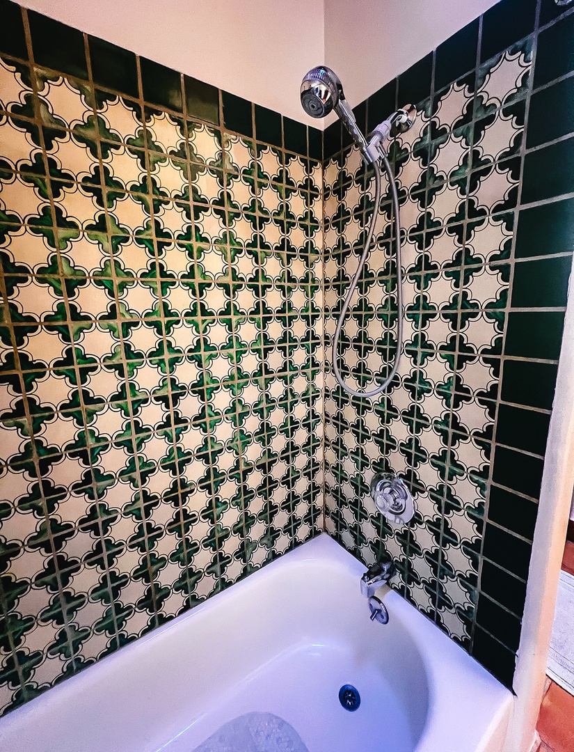 Unwind in your private bathroom featuring stunning handcrafted tilework and a deep soaking tub perfect for melting away stress.