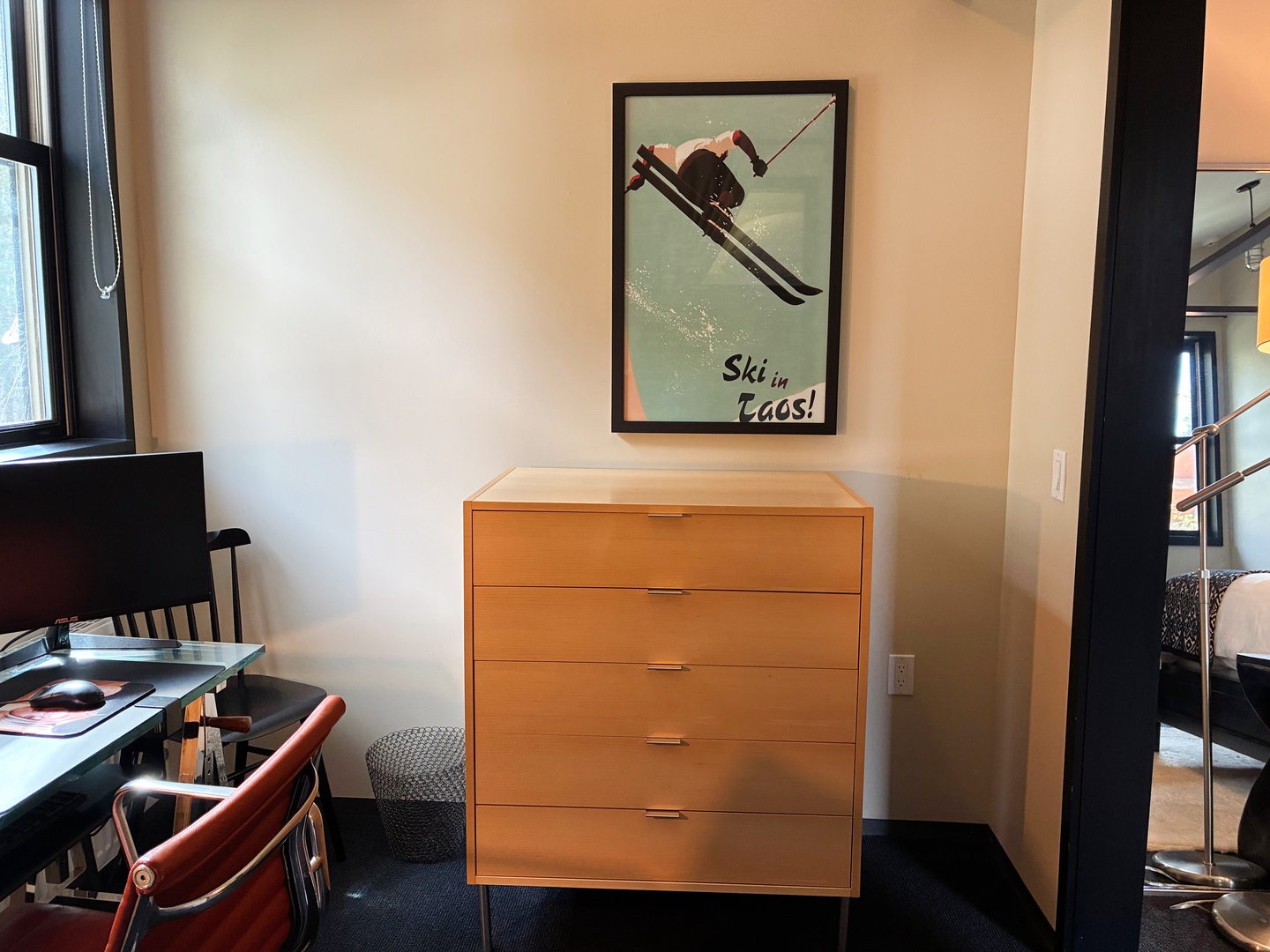Store your belongings in the sleek wooden dresser and settle into your comfortable space, complete with a charming desk area and mountain-inspired decor.