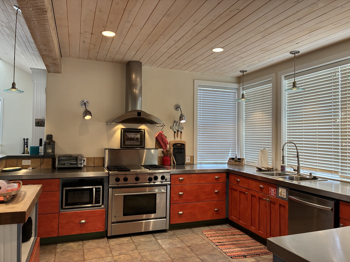 Cook your favorite meals in this fully-equipped kitchen, featuring quality appliances and warm wood cabinetry bathed in natural light.