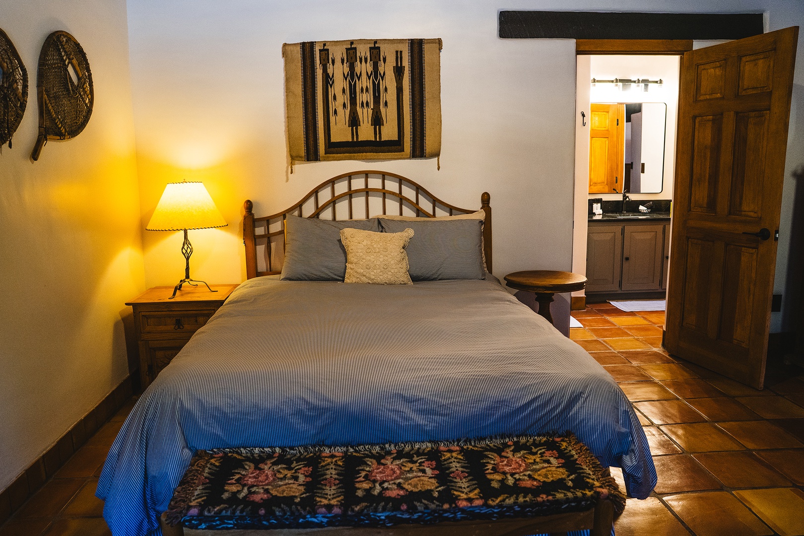 Unwind in your authentic southwestern bedroom with handcrafted furnishings, warm lighting, and traditional textiles creating a cozy retreat.