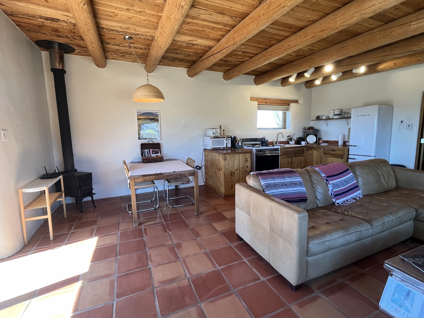 Relax in your rustic adobe retreat with exposed wooden beams and cozy fireplace warmth.