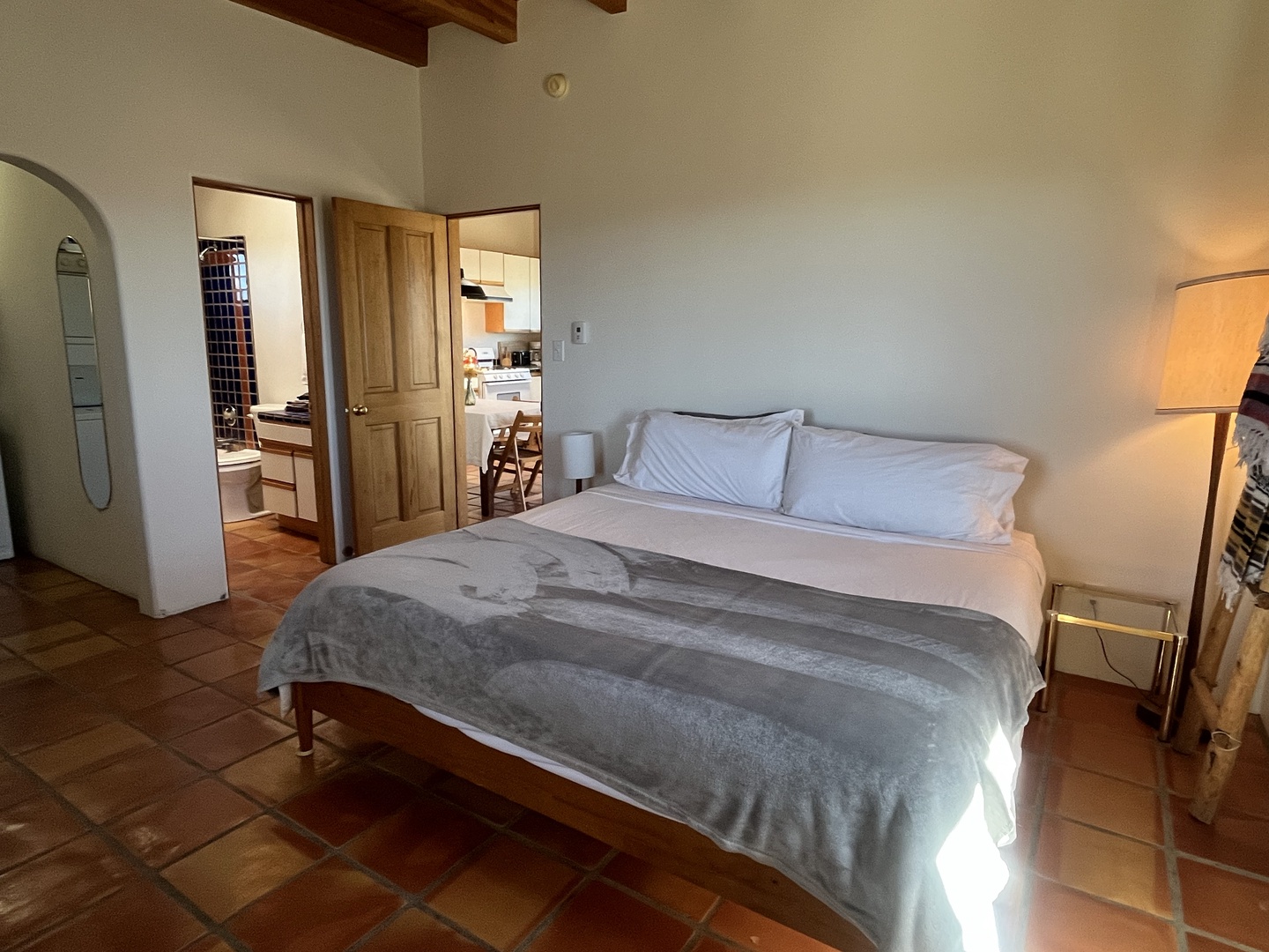 Rest peacefully in your charming bedroom with exposed wooden beams, terracotta floors, and crisp linens that invite deep, restful sleep.