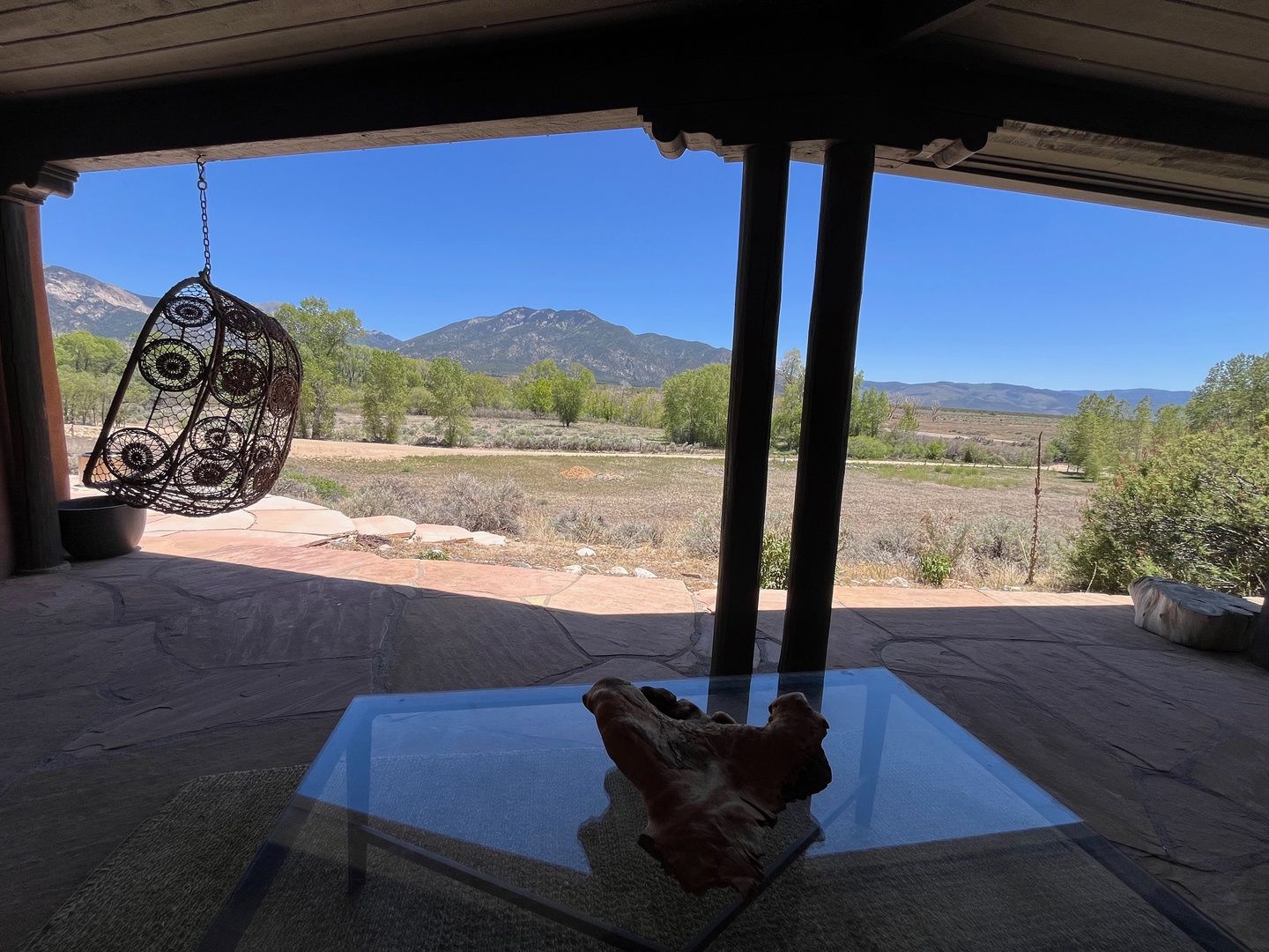 The patio opens to sweeping mountain views