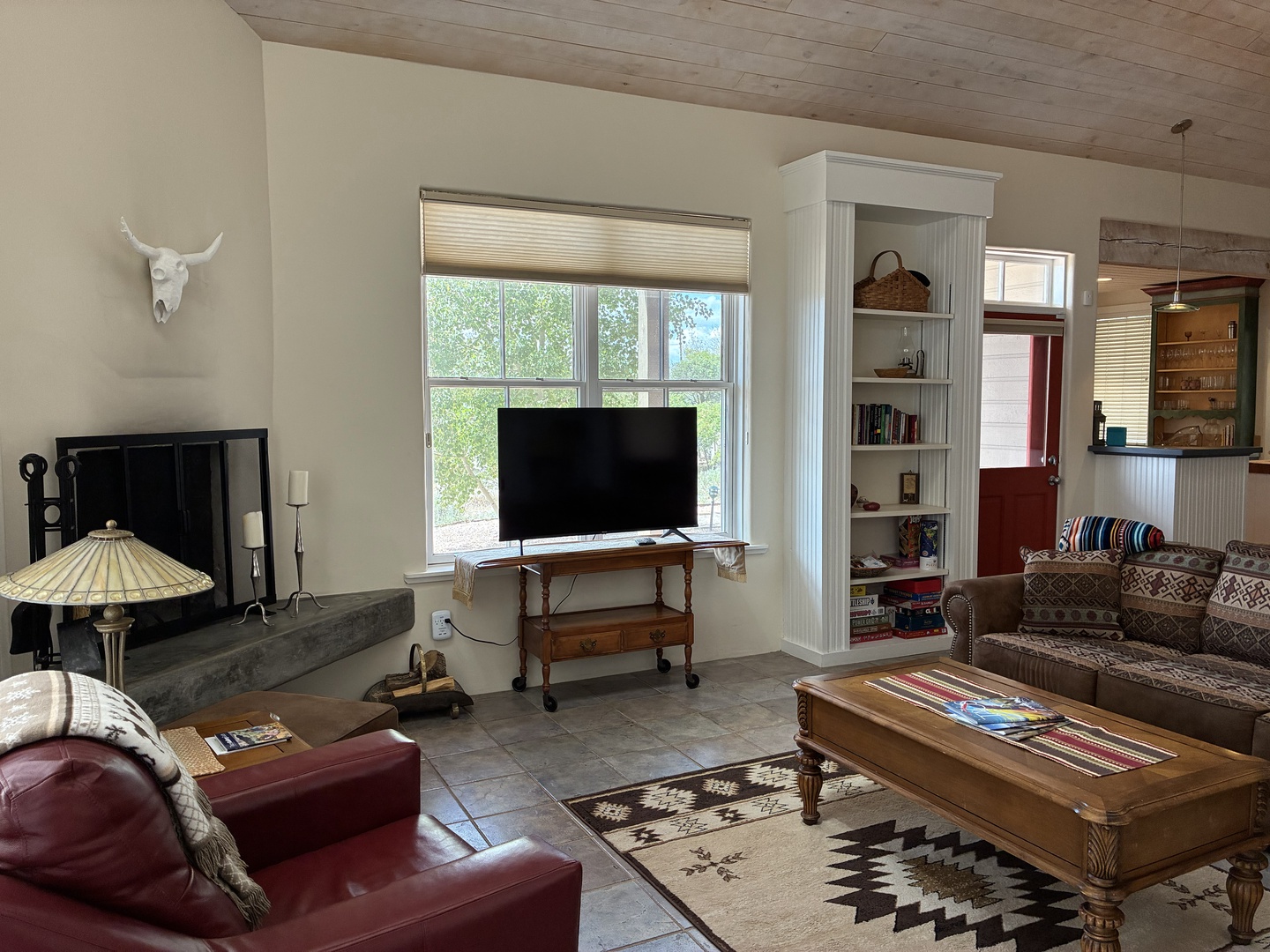 Sink into the leather seating and unwind in this bright living space, where wood ceilings and charming décor create a warm, inviting atmosphere for your mountain retreat.