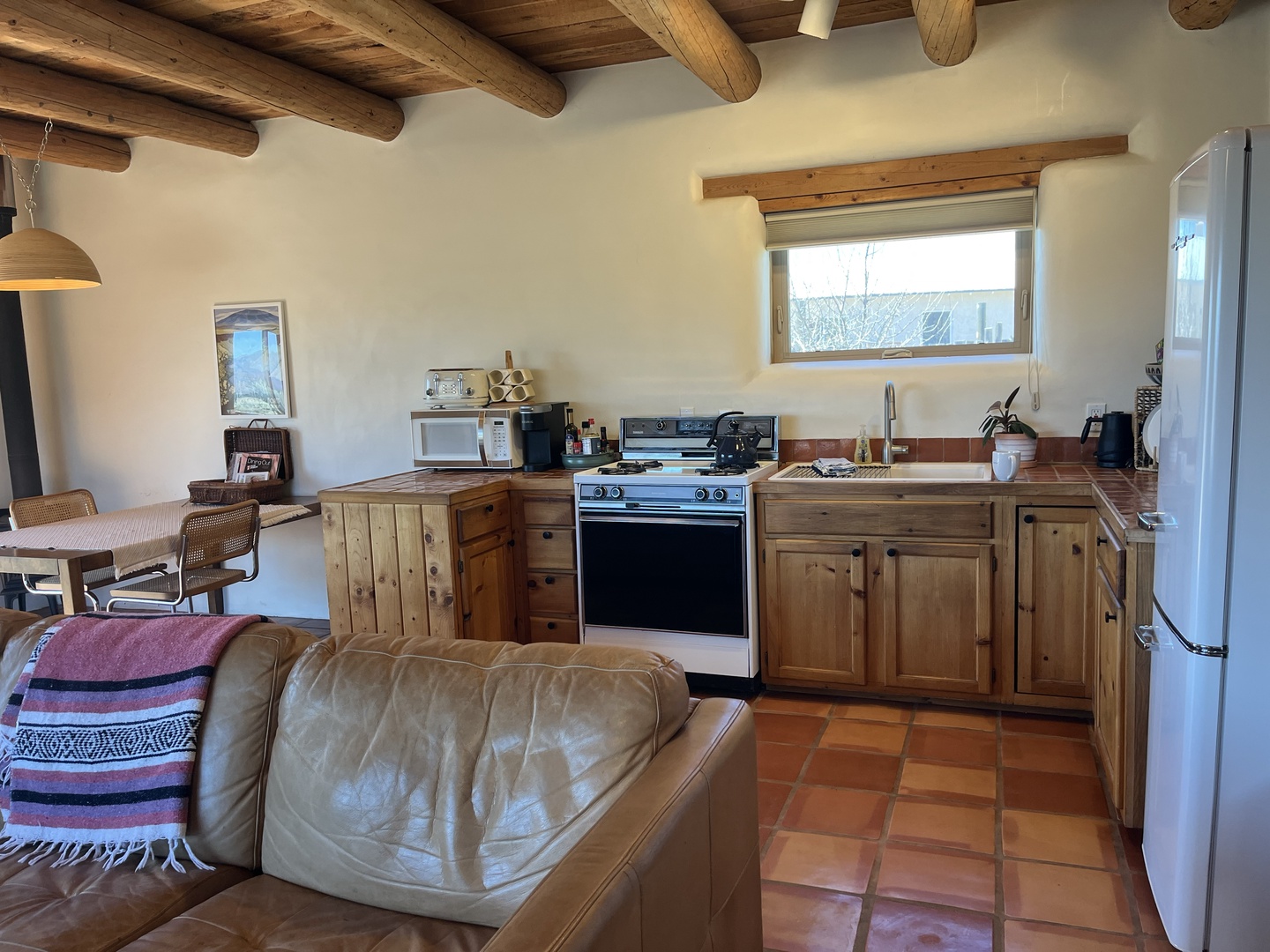 Your rustic kitchen welcomes you with wooden beams overhead and warm terra cotta floors beneath your feet.