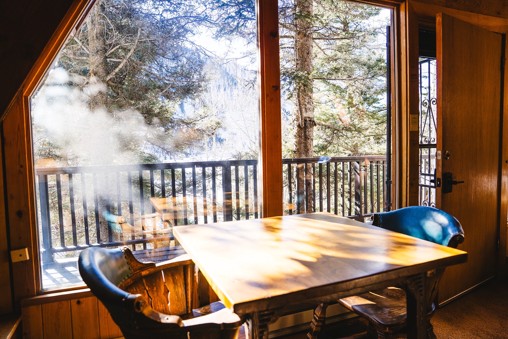 Cafe table catches warm sunlight in the front of the cabin