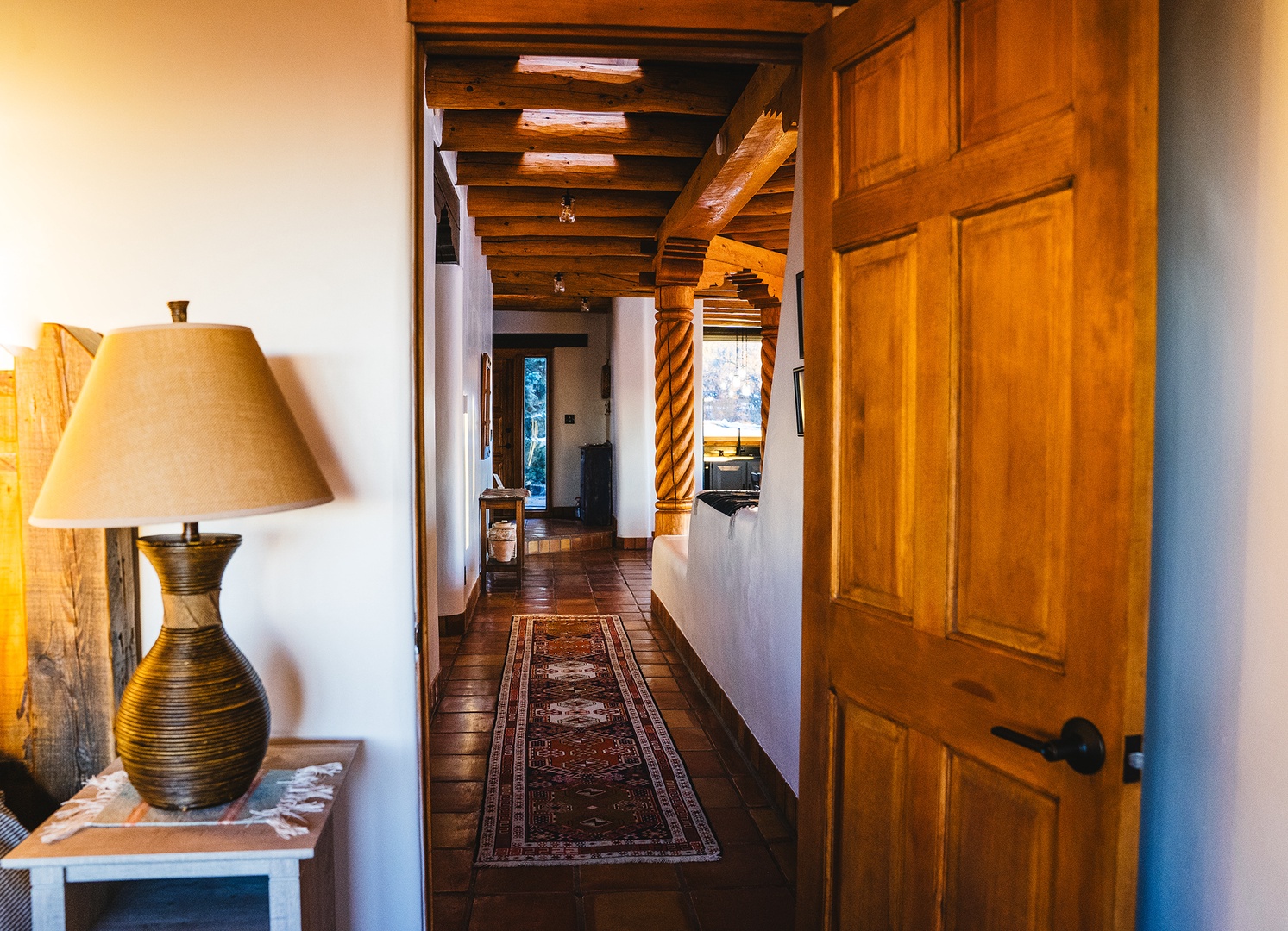 Step into your private sanctuary where rustic wood beams and warm lighting create an inviting atmosphere that feels like home.