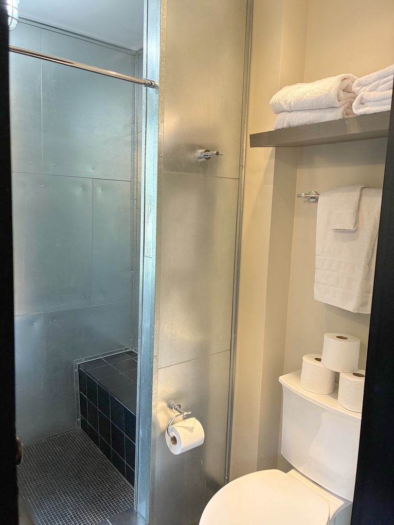 Step into your sparkling clean bathroom with a spacious walk-in shower and fresh towels waiting for you. Everything you need for a refreshing start to your day.