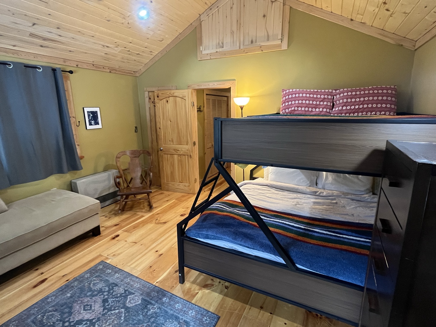 Your cozy room features comfortable bunk beds and a sofa, perfect for families or groups seeking a rustic mountain retreat.