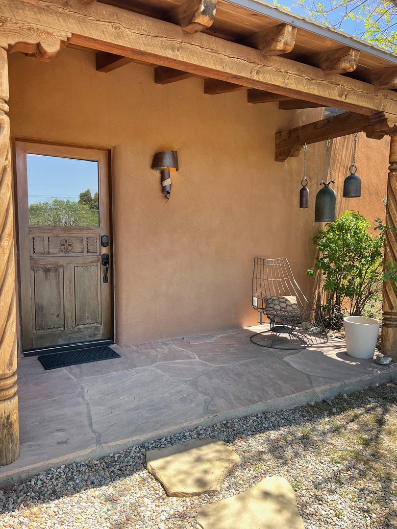 Covered entry with rustic timber beams and flagstone porch