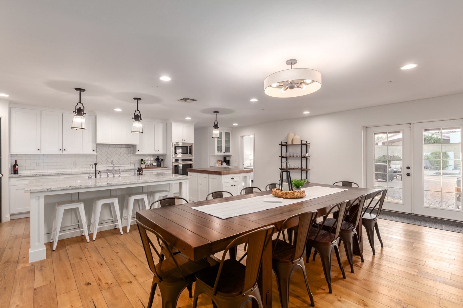 Adjacent to the kitchen and living room is a dining room table with seating for 12 people.