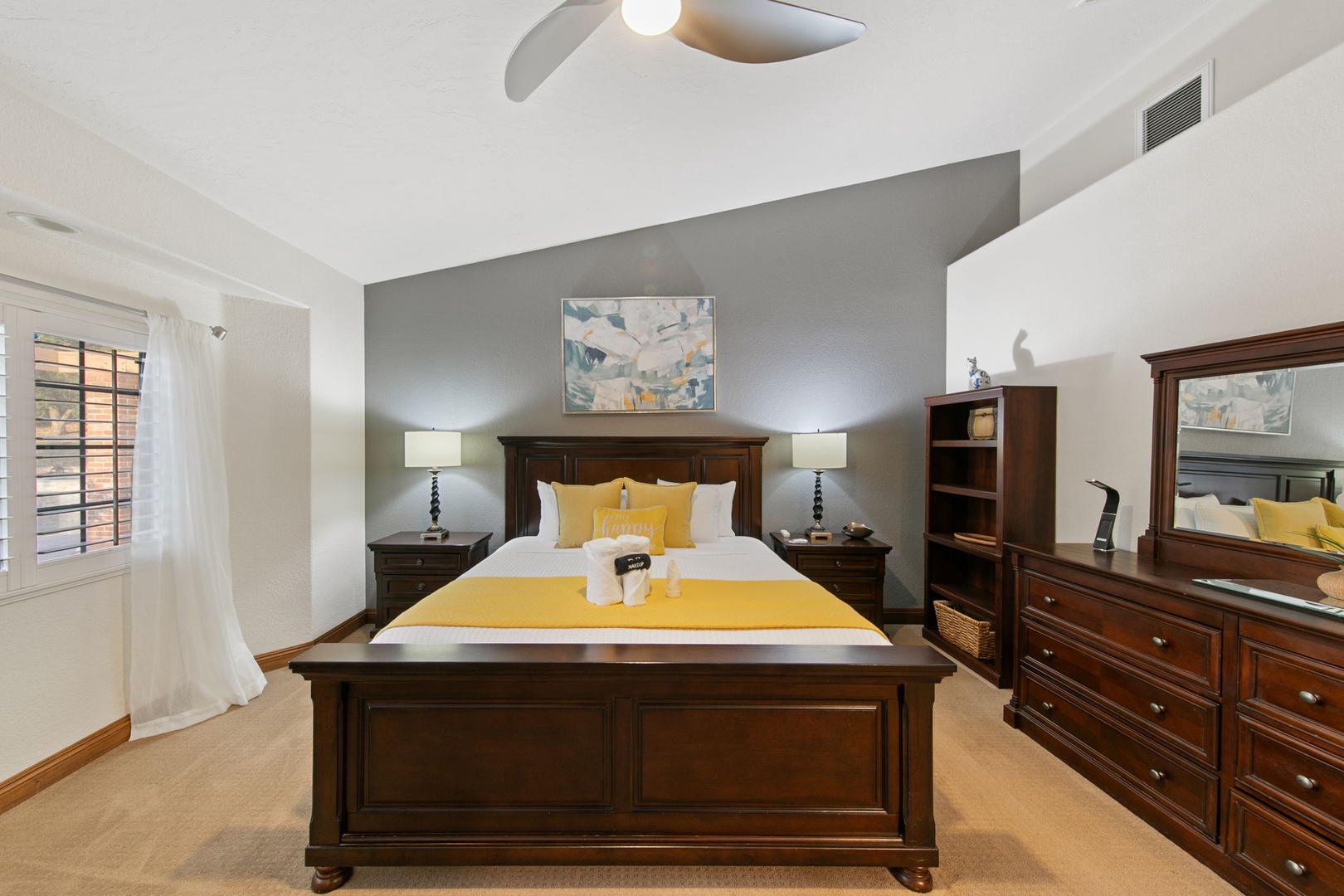 Unwind in your elegant primary suite featuring a plush king bed, cozy seating area, TV, and ensuite bathroom.