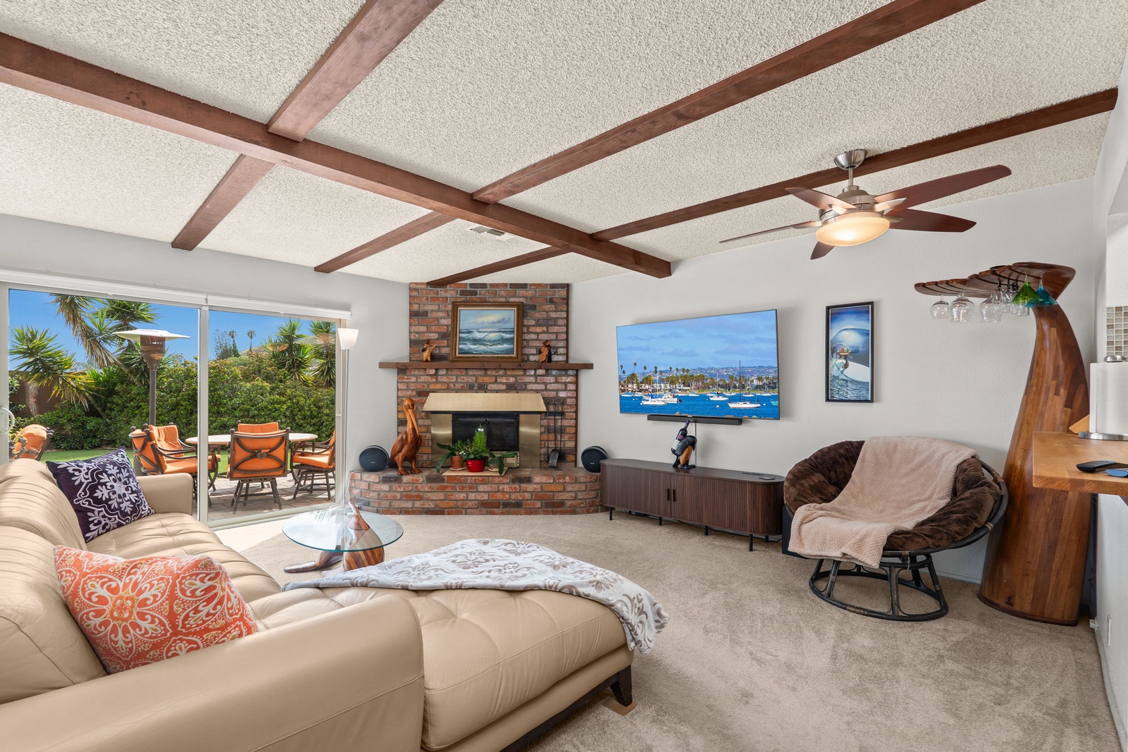 Relax in your spacious living room with exposed wood beams, cozy fireplace, and large TV for movie nights after exploring the coast.