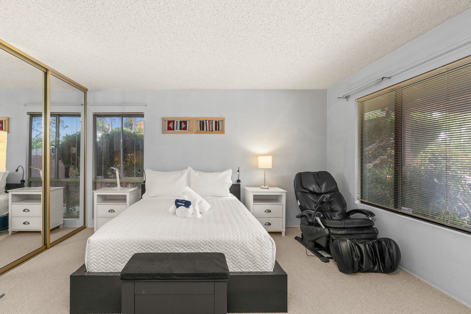 Relax in your serene bedroom with garden views and a luxurious massage chair for ultimate comfort after exploring the area.