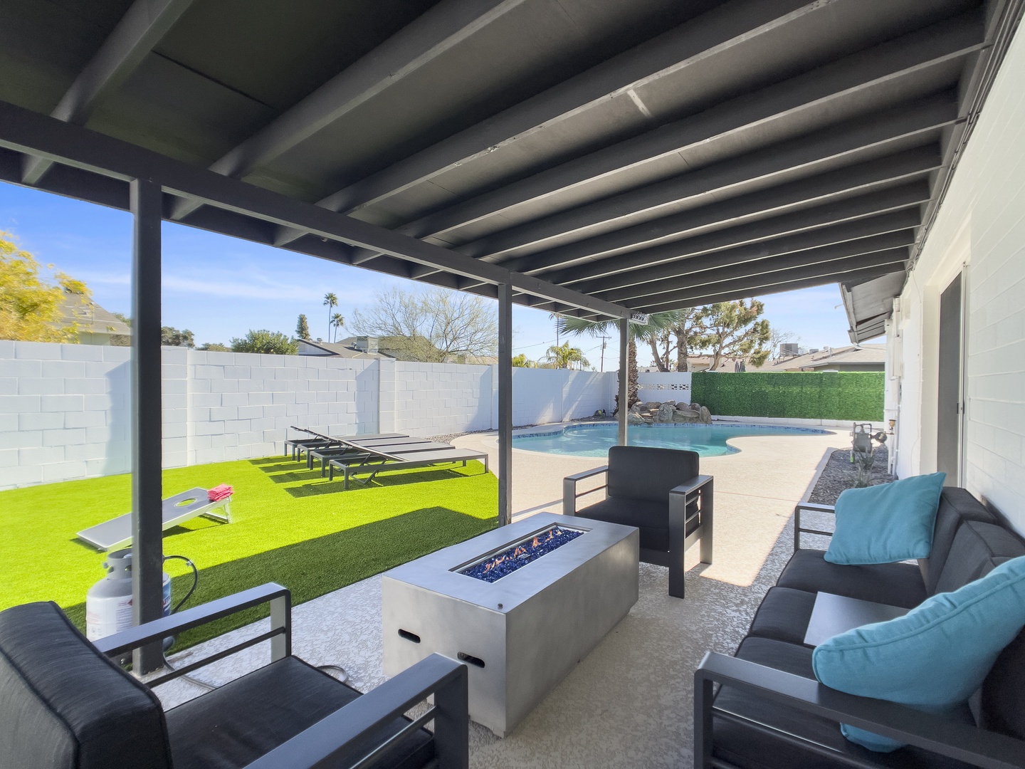 Outdoor covered lounge area with gas fire pit